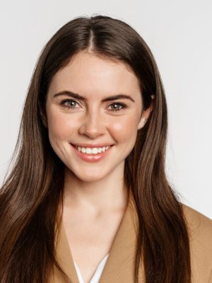 Real professional. Smiling businesswoman looking confident, determined face expression, standing in suit over white background.